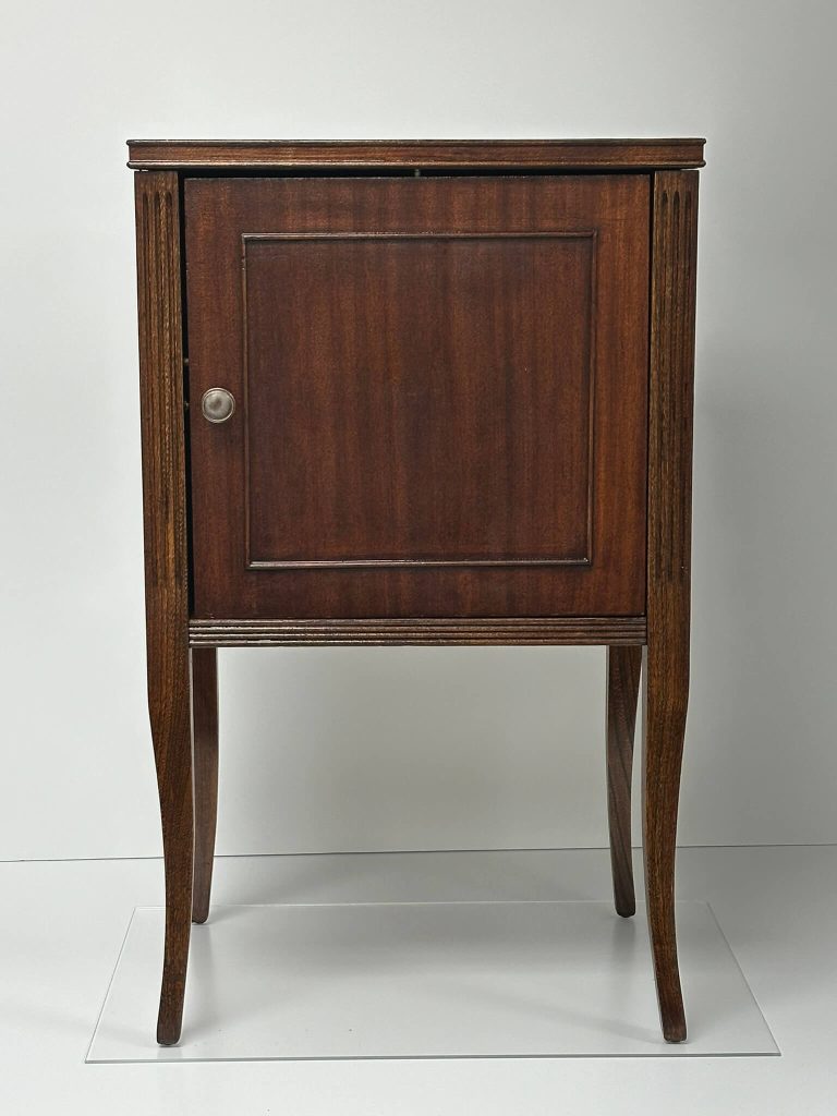 Elegant dark wood cabinet with a single door, silver knob, fluted columns, and slender