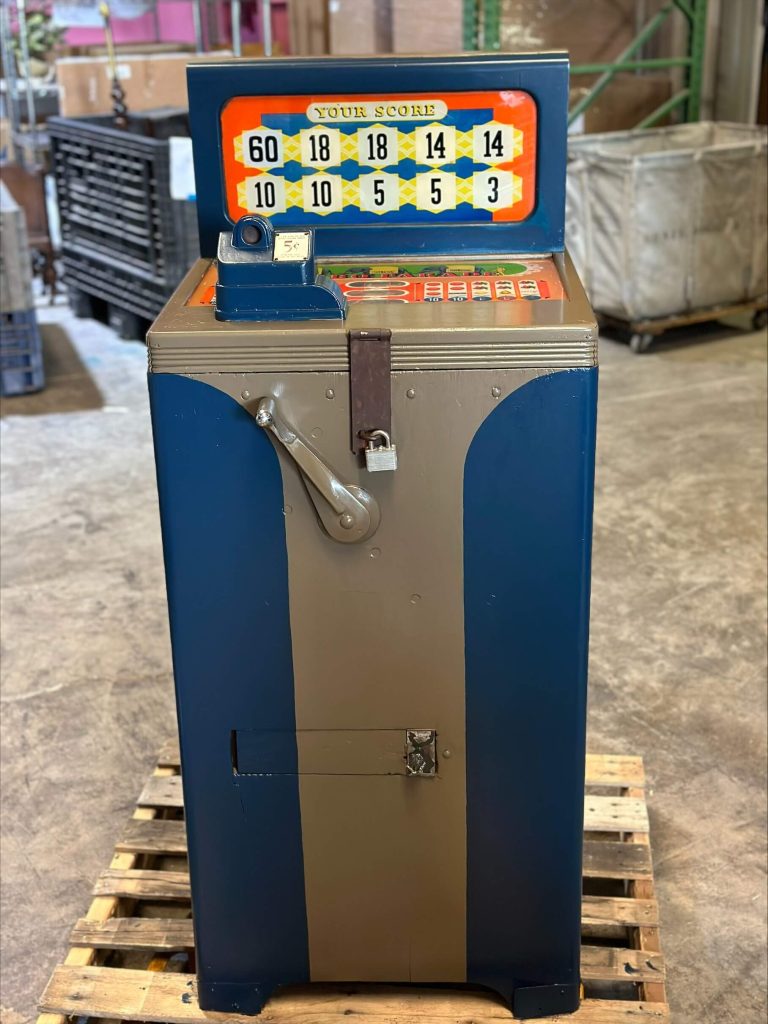 A tall, vintage blue and tan coin-operated game with a score display and side lever