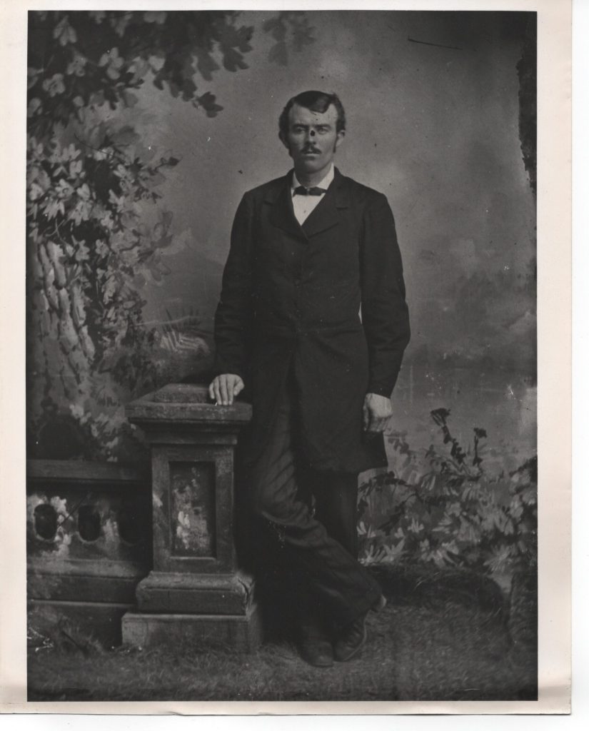 A black and white portrait of a 19th-century man in a