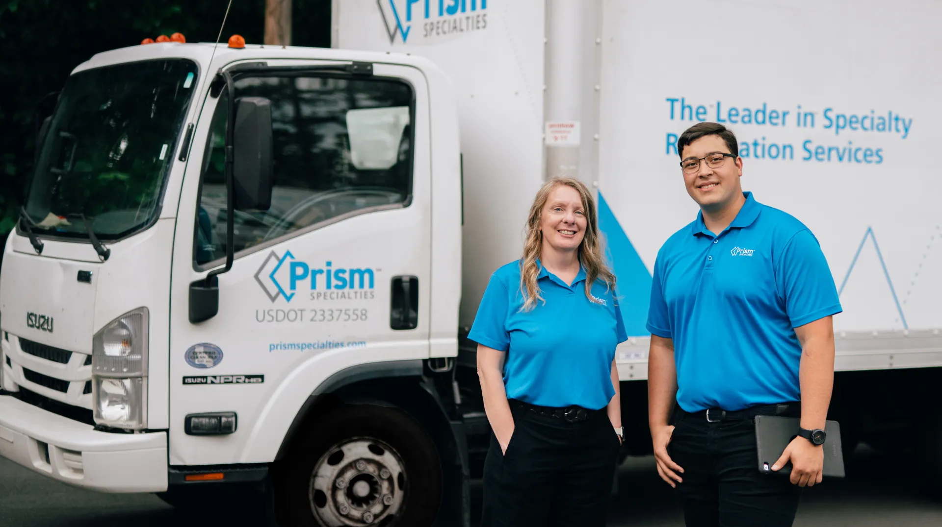 Prism restoration team with branded service truck