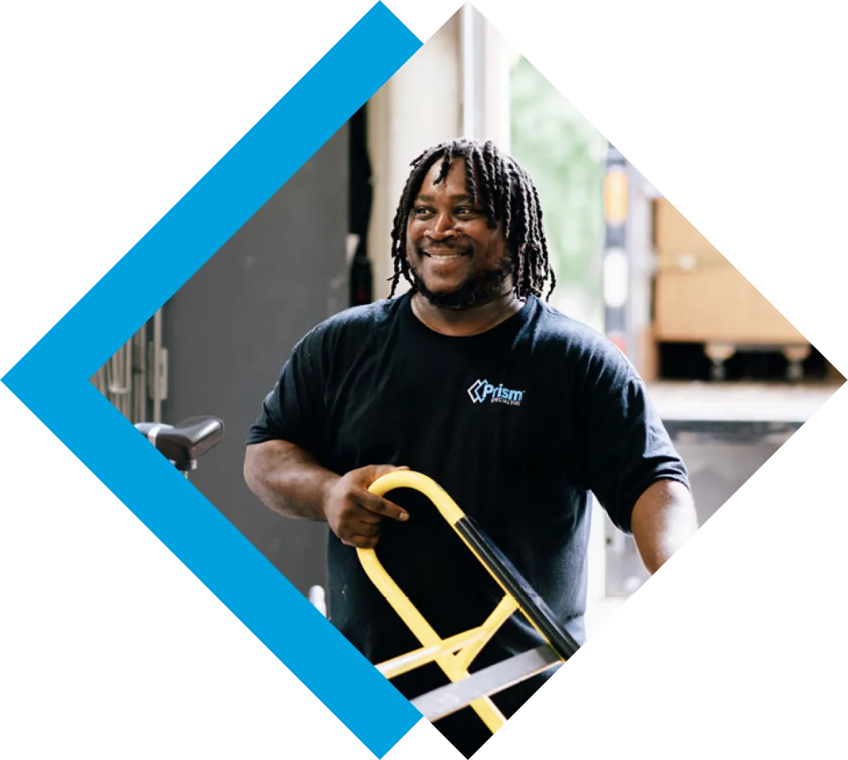 Prism technician with a hand truck at a loading dock