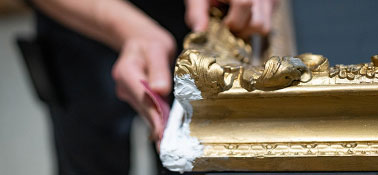 Person sanding an art frame