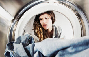 Woman looking into dryer