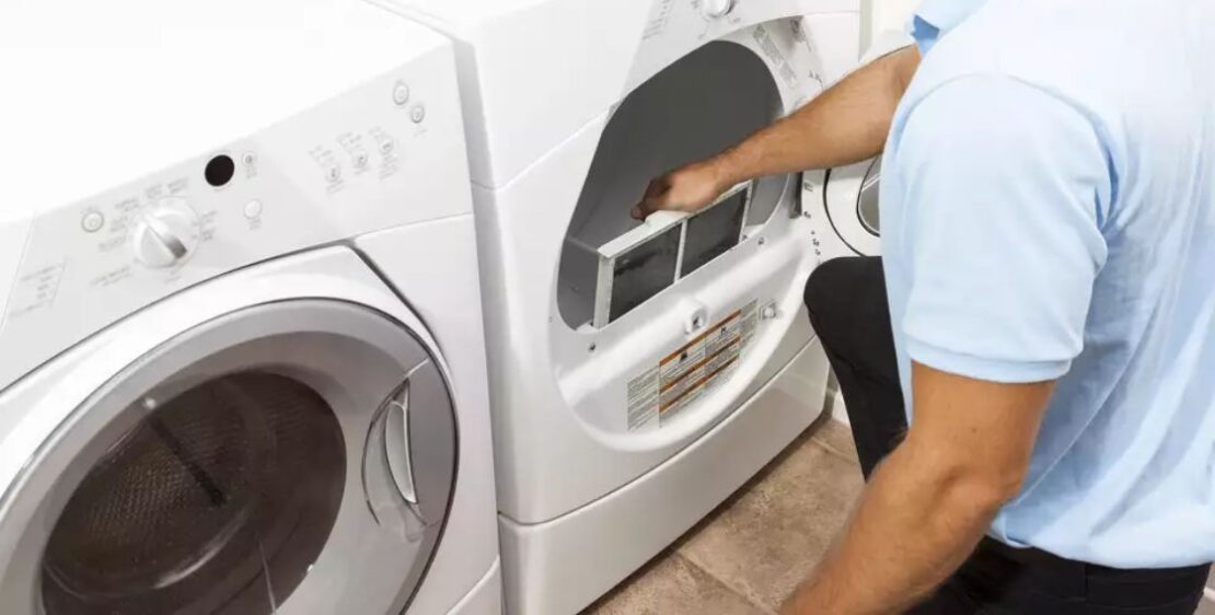 Man cleaning out dryer filter