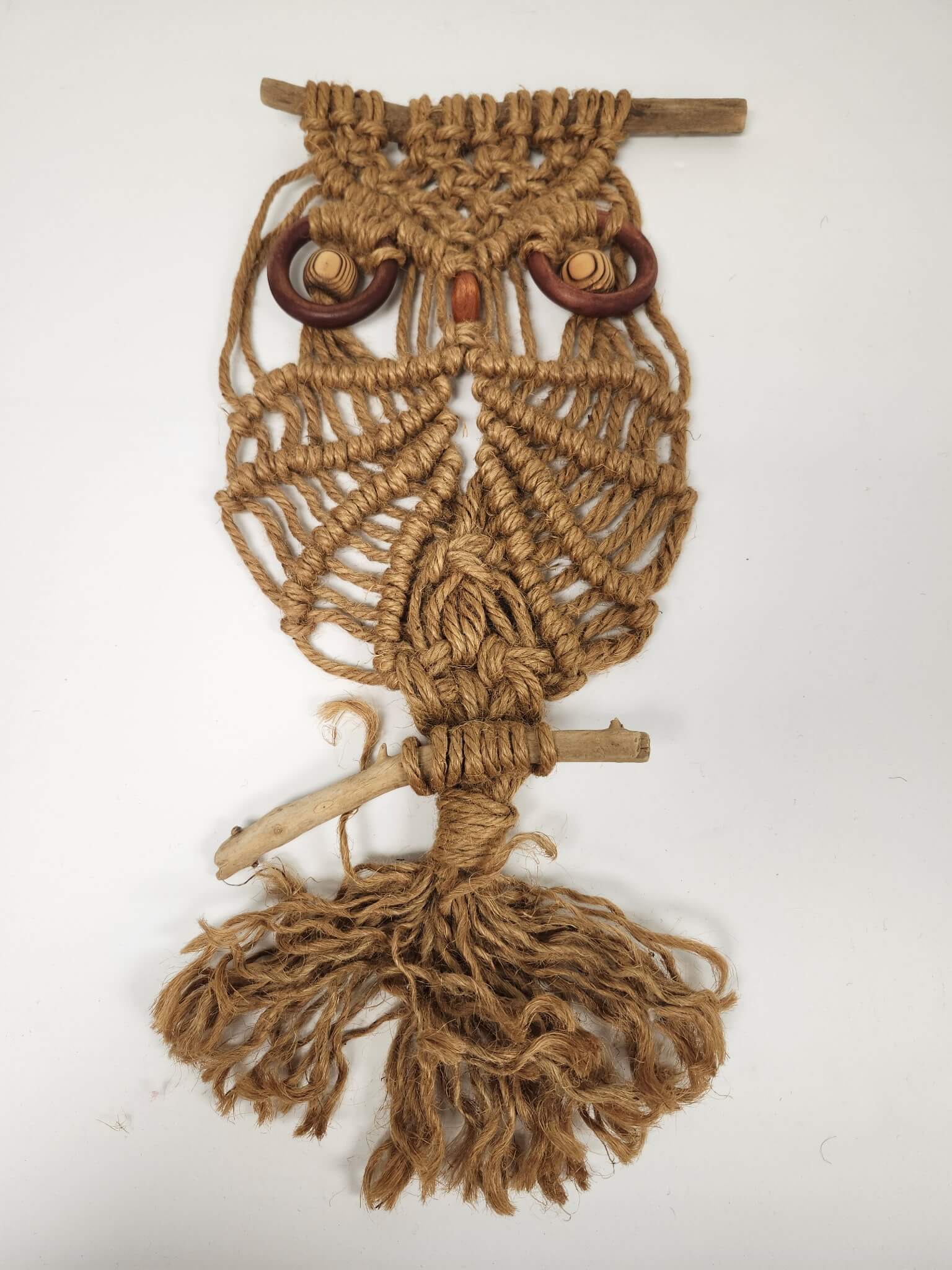 Macrame owl wall hanging after repair by Prism Specialties Columbus with knots rebuilt, fibers lifted, and original form restored