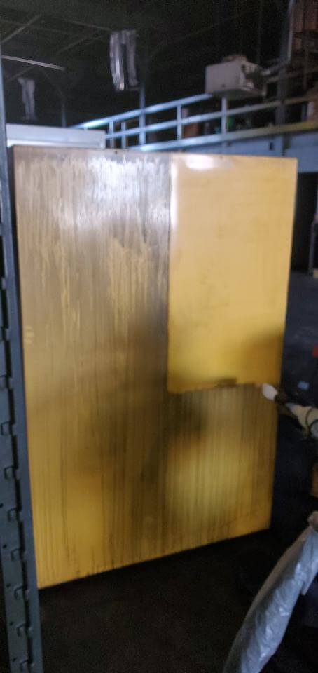 Industrial metal cabinet mid-clean — dry ice blasting visibly stripping years of contamination at a Columbus facility