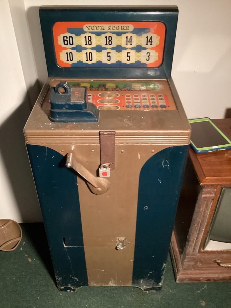 Vintage arcade game machine before restoration showing paint wear, cabinet damage, and aged hardware