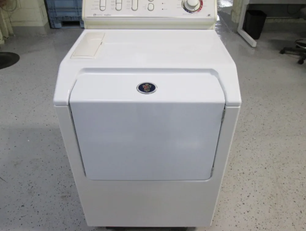 A white laundry appliance with a top control panel and a blue and gold circular emblem on its